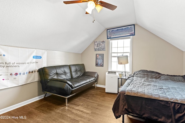 bedroom with ceiling fan, hardwood / wood-style floors, and lofted ceiling