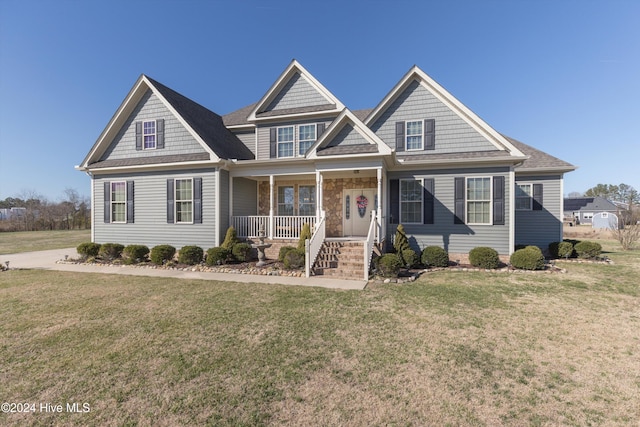 view of front of house featuring covered porch and a front lawn