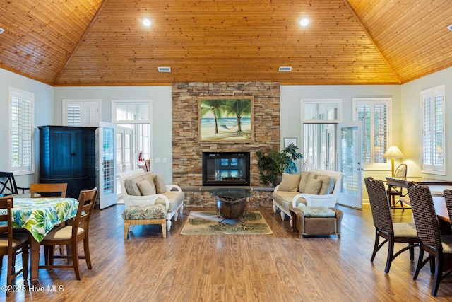 living room featuring high vaulted ceiling, wood-type flooring, a fireplace, and wooden ceiling