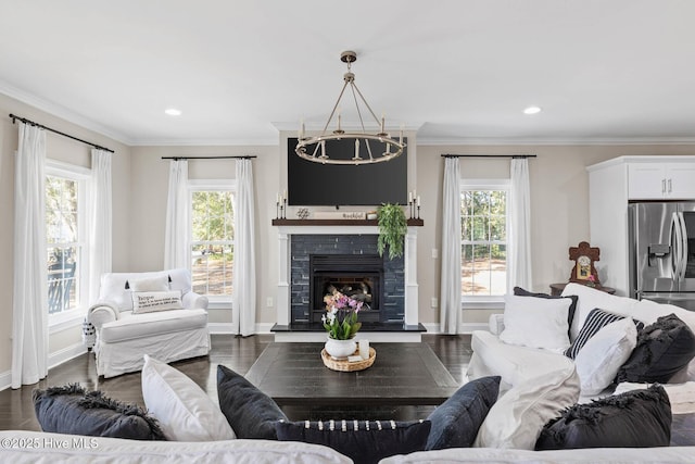 living room featuring dark hardwood / wood-style flooring, plenty of natural light, and a notable chandelier