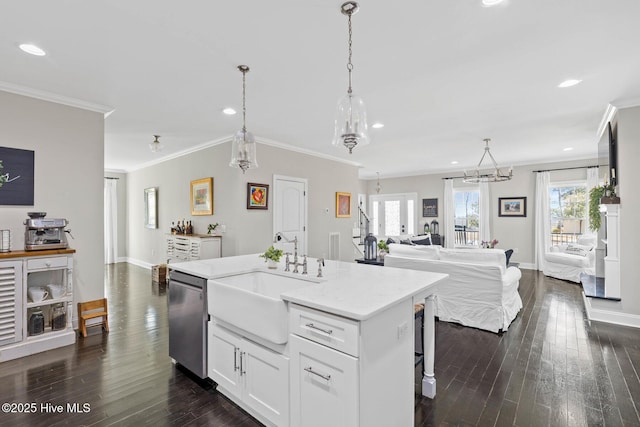 kitchen with dark wood-style flooring, dishwasher, a sink, ornamental molding, and white cabinetry