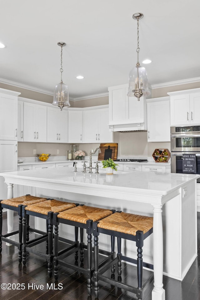 kitchen with crown molding, white cabinets, stainless steel appliances, and recessed lighting
