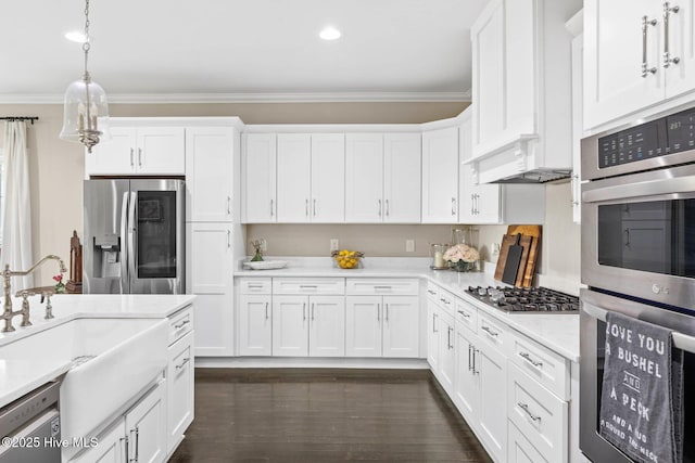 kitchen with stainless steel appliances, white cabinetry, and decorative light fixtures