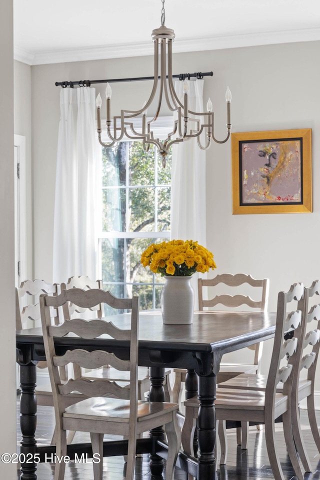dining area with an inviting chandelier and ornamental molding