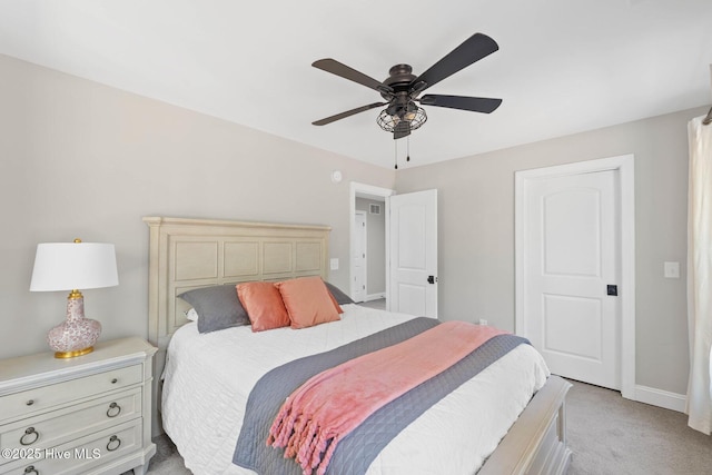 bedroom with baseboards, ceiling fan, and light carpet