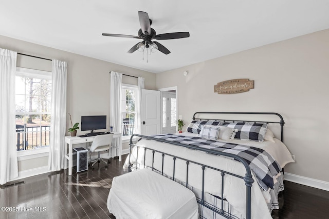 bedroom featuring baseboards, a ceiling fan, wood finished floors, and visible vents