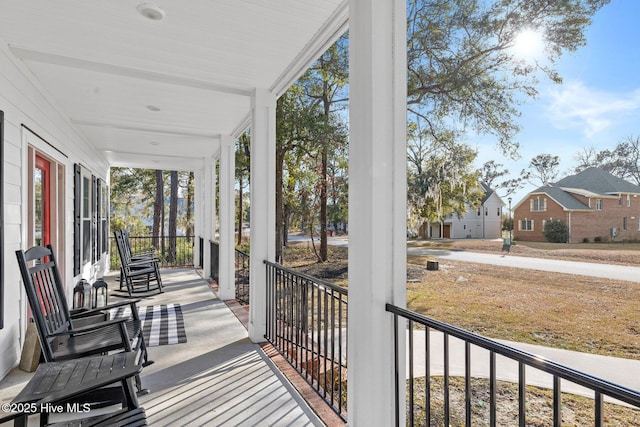 exterior space featuring covered porch and a residential view