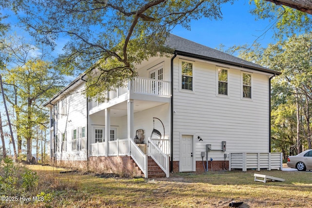 exterior space with a balcony and a yard