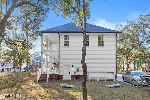 view of property exterior with a balcony and a yard