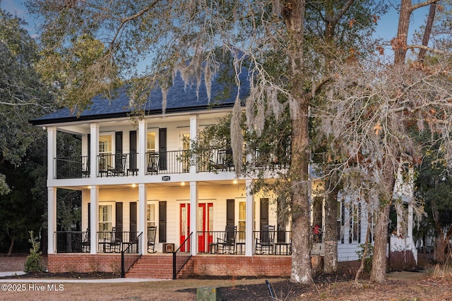 view of front of home with a porch and a balcony