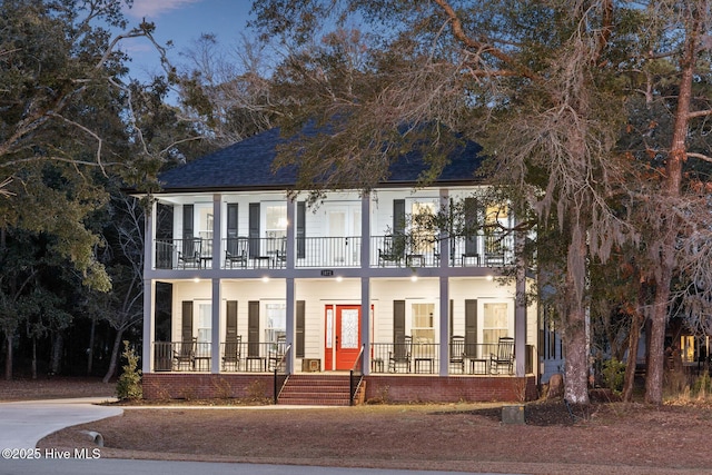 view of front of property with a balcony and a porch