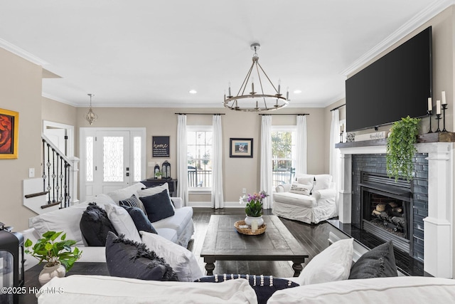 living area with a fireplace, stairway, baseboards, dark wood-style floors, and an inviting chandelier