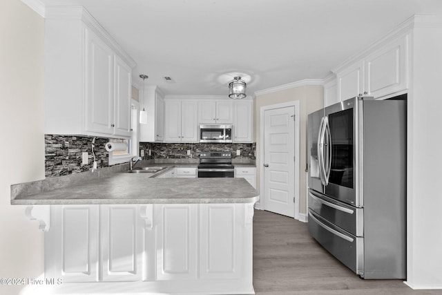 kitchen with kitchen peninsula, white cabinetry, wood-type flooring, and appliances with stainless steel finishes