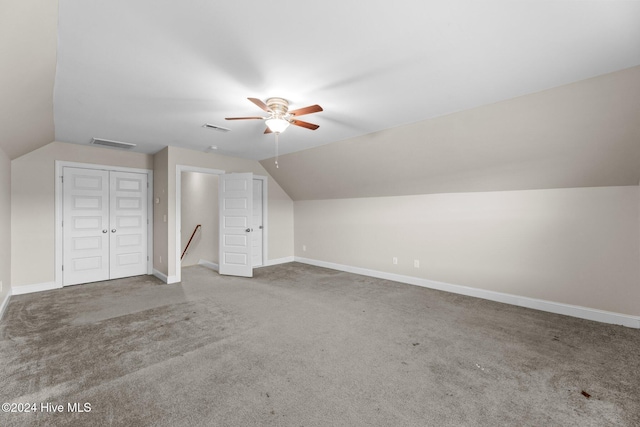 additional living space featuring carpet flooring, vaulted ceiling, and ceiling fan