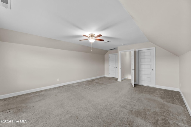 additional living space with carpet, vaulted ceiling, and ceiling fan