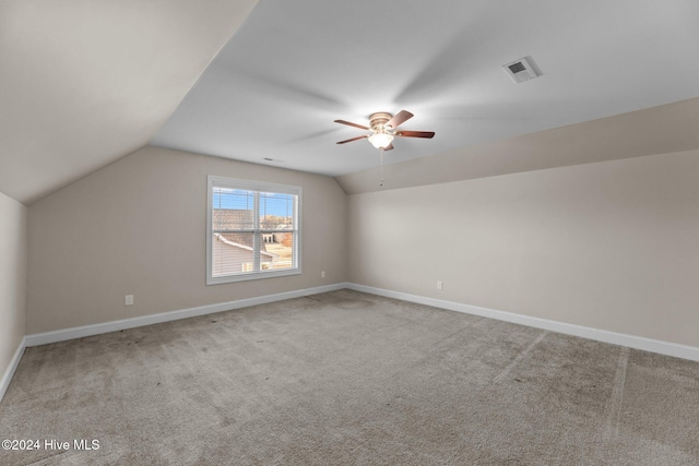 bonus room with light carpet and lofted ceiling