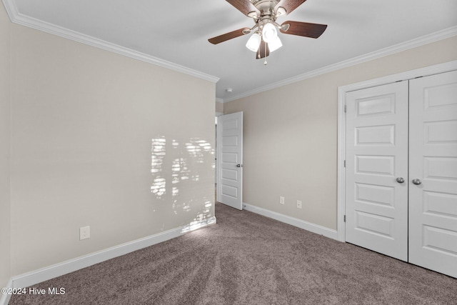 unfurnished bedroom with carpet, ceiling fan, ornamental molding, and a closet