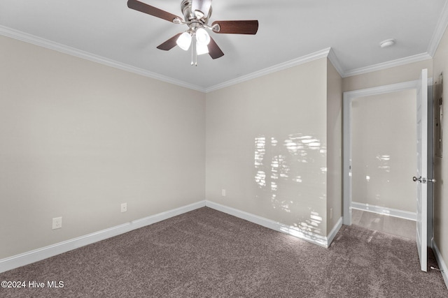 carpeted spare room with ceiling fan and crown molding