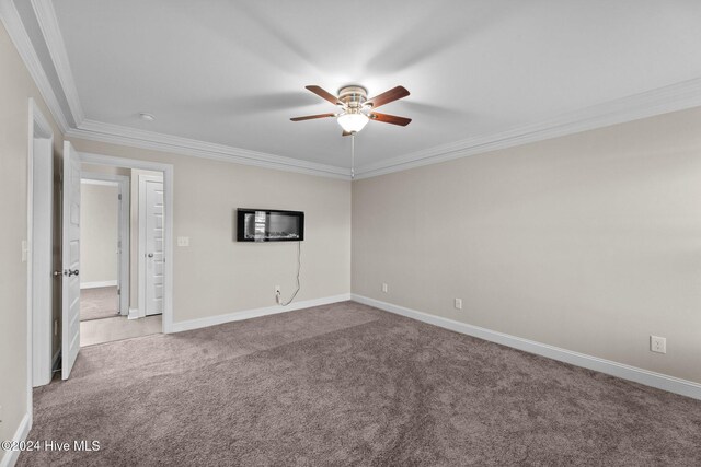 carpeted empty room with ceiling fan and ornamental molding