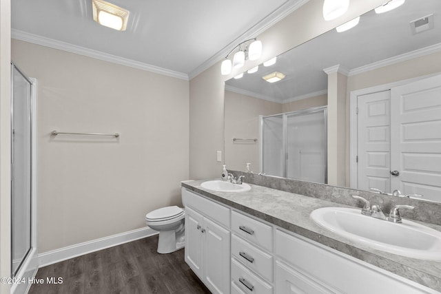 bathroom featuring hardwood / wood-style flooring, toilet, a shower with door, and ornamental molding