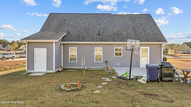 rear view of house with a yard