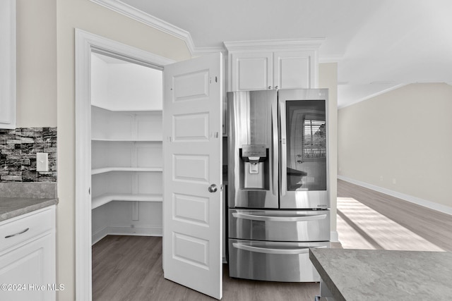 kitchen with white cabinetry, stainless steel fridge with ice dispenser, crown molding, and light hardwood / wood-style flooring