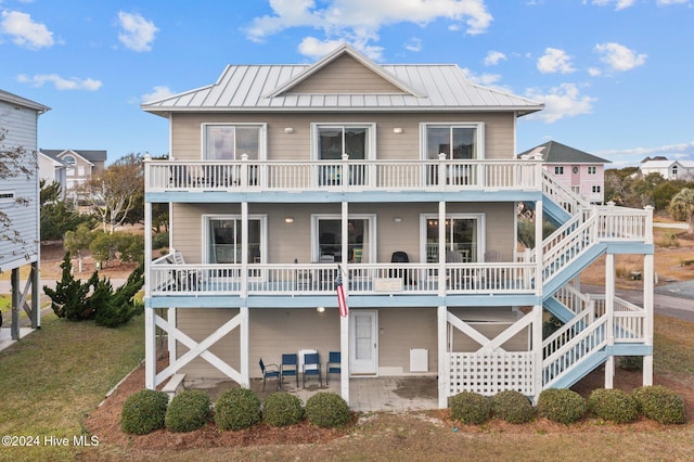 rear view of property with a lawn