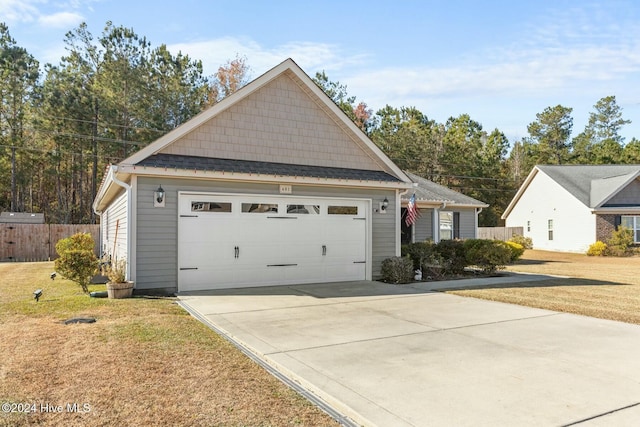 view of front of home with a garage and a front lawn