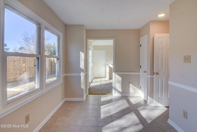 corridor featuring light tile patterned floors