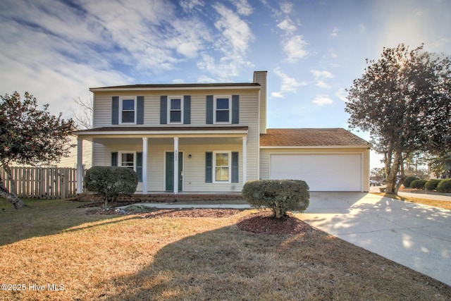 view of front of property with a garage, a front yard, and covered porch