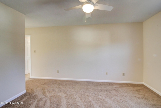 unfurnished room featuring ceiling fan and light carpet