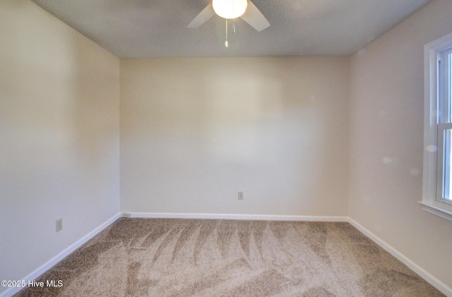 spare room featuring carpet floors and ceiling fan