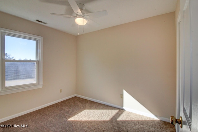 carpeted spare room featuring ceiling fan