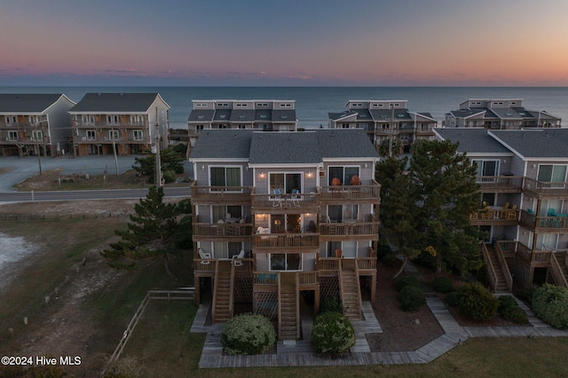 exterior space featuring stairway, a residential view, and a water view