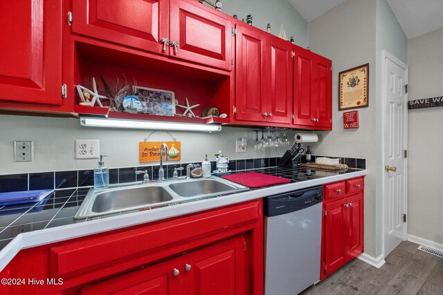 kitchen with appliances with stainless steel finishes, light wood-type flooring, and vaulted ceiling with skylight