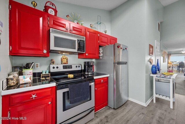 kitchen featuring dishwasher, light wood-type flooring, high vaulted ceiling, and ceiling fan