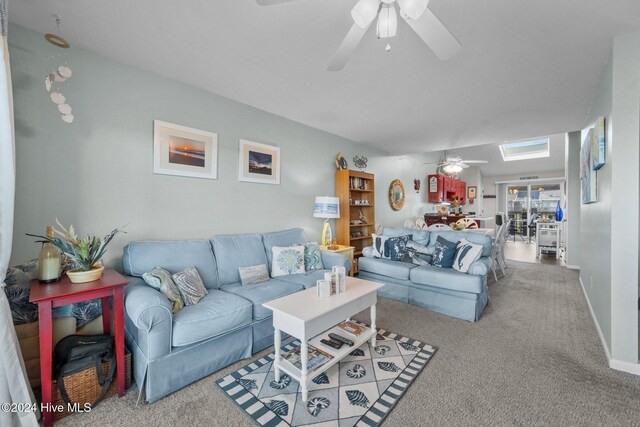 dining area with lofted ceiling with skylight, ceiling fan, and wood-type flooring