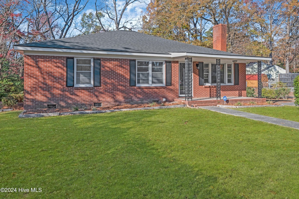 single story home featuring a porch and a front yard