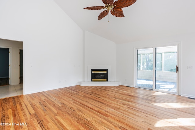 unfurnished living room with light wood-type flooring, high vaulted ceiling, and ceiling fan