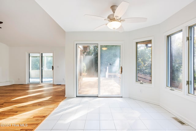 spare room featuring ceiling fan, plenty of natural light, and light wood-type flooring