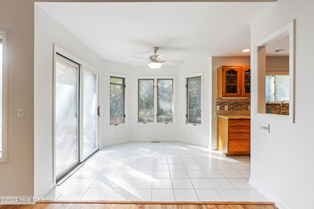 interior space with ceiling fan and a wealth of natural light