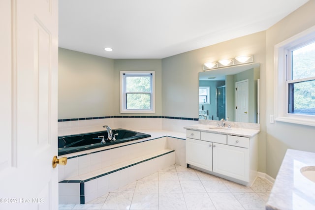 bathroom with separate shower and tub, tile patterned flooring, and vanity