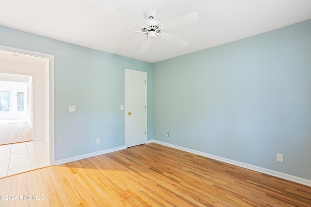 spare room with light hardwood / wood-style flooring and ceiling fan