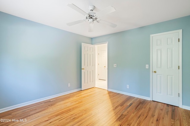 spare room featuring light hardwood / wood-style flooring and ceiling fan