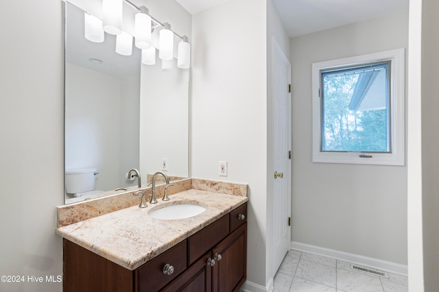 bathroom with vanity and toilet