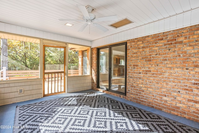 unfurnished sunroom featuring ceiling fan