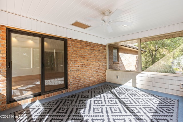 unfurnished sunroom featuring ceiling fan