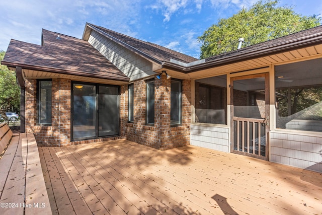 wooden deck with a sunroom