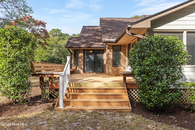 view of exterior entry with a deck