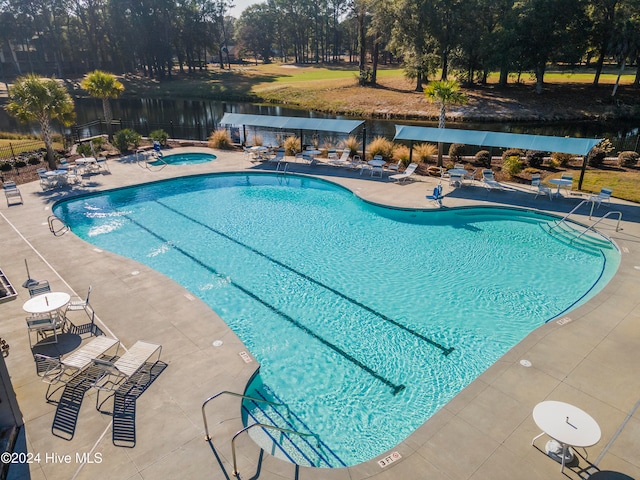 view of swimming pool featuring a community hot tub and a patio